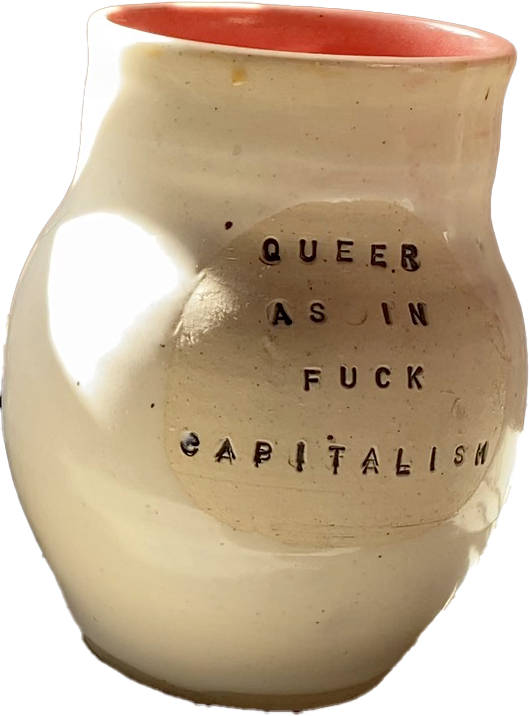 Photo of a ceramic mug that says Queer as in Fuck Capitalism